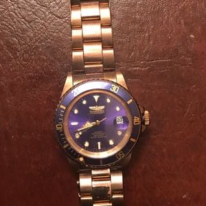 Beautiful gold Invicta men’s watch with blue face.